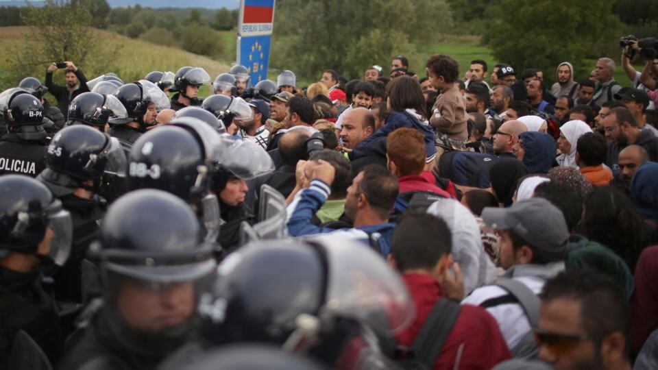 Migrants are held back by Slovenian riot police. Photograph: Christopher Furlong/Getty Images