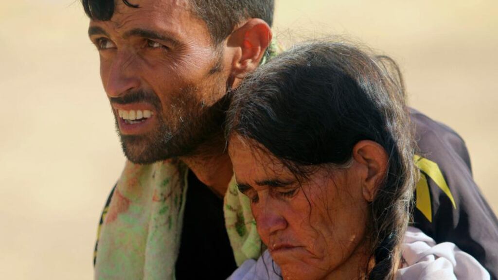 A displaced man and a woman from the minority Yazidi sect, fleeing violence from forces loyal to the Islamic State in Sinjar town. Picture taken August 11, 2014. REUTERS/Rodi Said