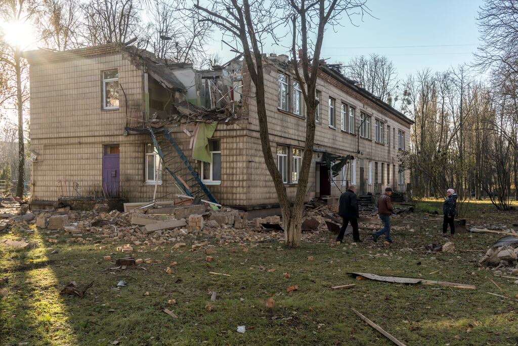 Local residents and investigators examine a daycare that was damaged by a Russian drone attack in Kyiv on Saturday. Photograph: Brendan Hoffman/The New York Times