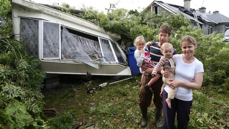 Noel and Mary Kelly with their children Adam and Grace at their mobile home from which they had a lucky escape during the freak weather at Killoran, Clonfert. Photograph: Joe O’Shaughnessy.
