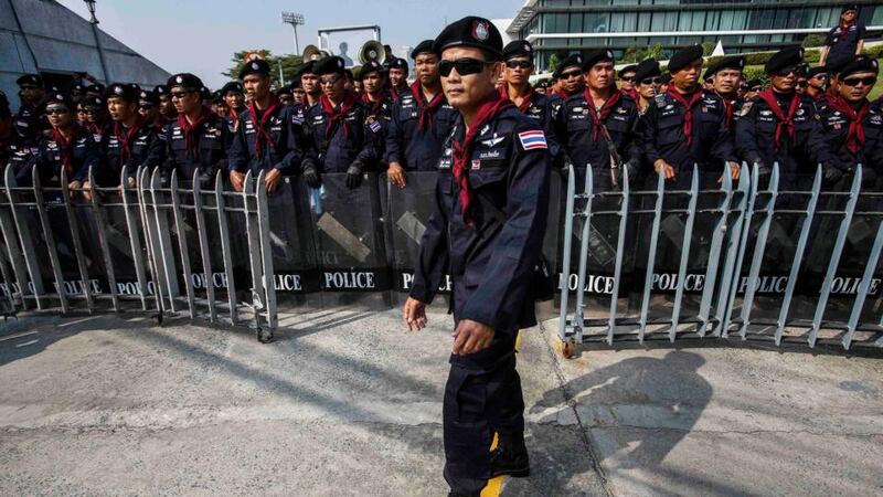 Riot policemen stand guard outside the Army Club where the prime minister Yingluck Shinawatra held her cabinet meeting this morning. Photograph: Athit Perawongmetha/Reuters