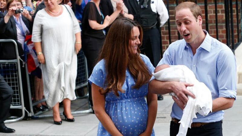 William presents his new son to cheering crowds in London this evening. Photograph: Reuters