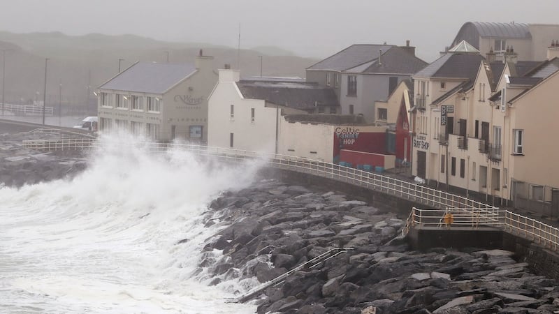Waves crash agains the sea wall in Lahinch as thousands of homes and businesses have been left without power. Photograph: Brian Lawless/PA Wire.