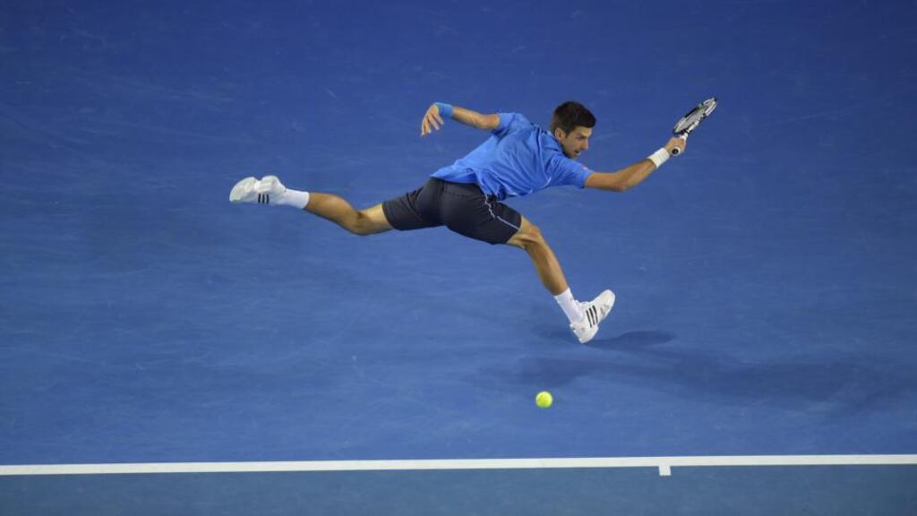 Novak Djokovic stretches to hit a backhand return during his match against Gilles Muller at the Australian Open in Melbourne. Photograph: Lukas Coch/EPA
