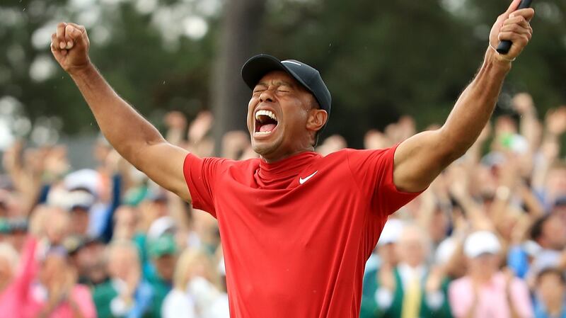 Tiger Woods celebrates after sinking his putt on the 18th green to win the Masters at Augusta National. Photograph: Andrew Redington/Getty