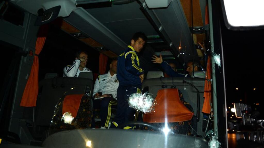 Fenerbahce’s player Emre Belozoglu (c) and head coach Ismail Kartal (r) standing inside their bus after an attack by a gunman on a highway in northern Turkey. Photograph: STR/EPA