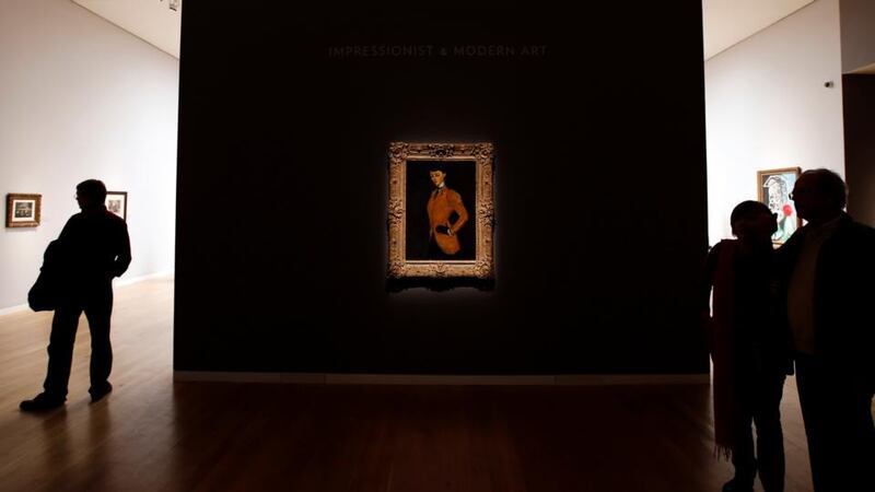 Visitors walk near Amedeo Modigliani’s painting ‘Amazone’ painted 1909.  Photograph: Mike Segar/Reuters