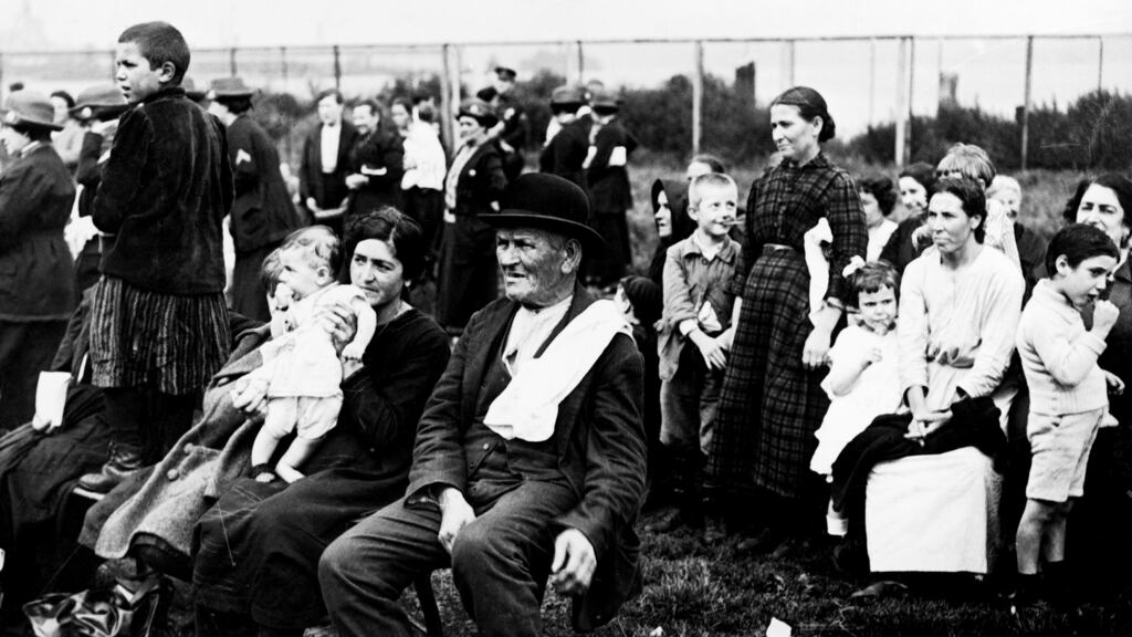 An Irish immigrant sits on a chair next to an Italian and her children at Ellis Island in the early 20th century. Photograph: FPG/Getty Images