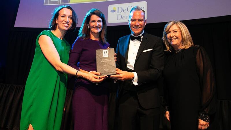 David Casey, Wellness and Health Promotion Manager, DeCare Dental, presents the Best Health & Wellbeing Strategy award to Isobel Tynan, Sarah Downing & Pauleen Swift, Goodbody.