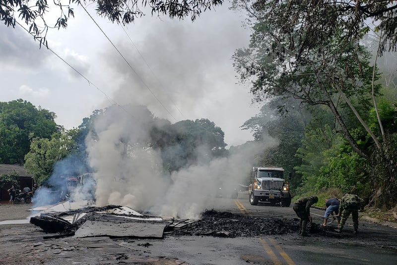 Colombian soldiers remove debris from truck burned by the Clan del Golfo in Taraza, Cauca, Colombia, in March. Photograph: Eder Narvaez /AFP via Getty Images