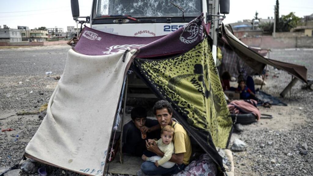 Syrian refugees shelter near the Turkish border post of Akcakale. Photograph: Bulent Kilic/AFP/Getty Images