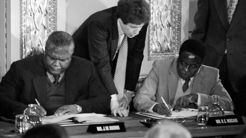 Joshua Nkomo and Robert Mugabe  signing the Rhodesia ceasefire agreement in London in December 1979.  Photograph: PA