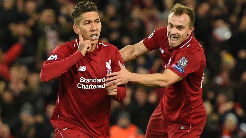 Xherdan Shaqiri celebrates with Roberto Firmino after the Brazilian opened the scoring in the Champions League Group C match against Red Star Belgrade at Anfield. Photograph: Oli Scarff/AFP/Getty Images
