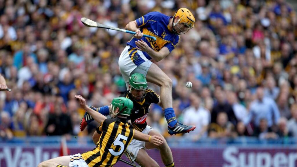 Tipperary’s Séamus Callanan tussles with goalkeeper Eoin Murphy and Joey Holden of Kilkenny during yesterday’s All-Ireland final draw at Croke Park. Photograph: Ryan Byrne/Inpho