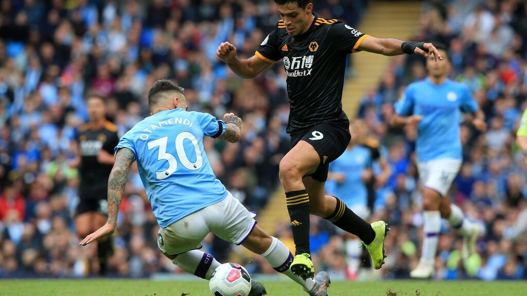 Nicolas Otamendi misses a tackle on Wolverhampton Wanderers’ striker Raul Jimenez. Photograph: Getty Images