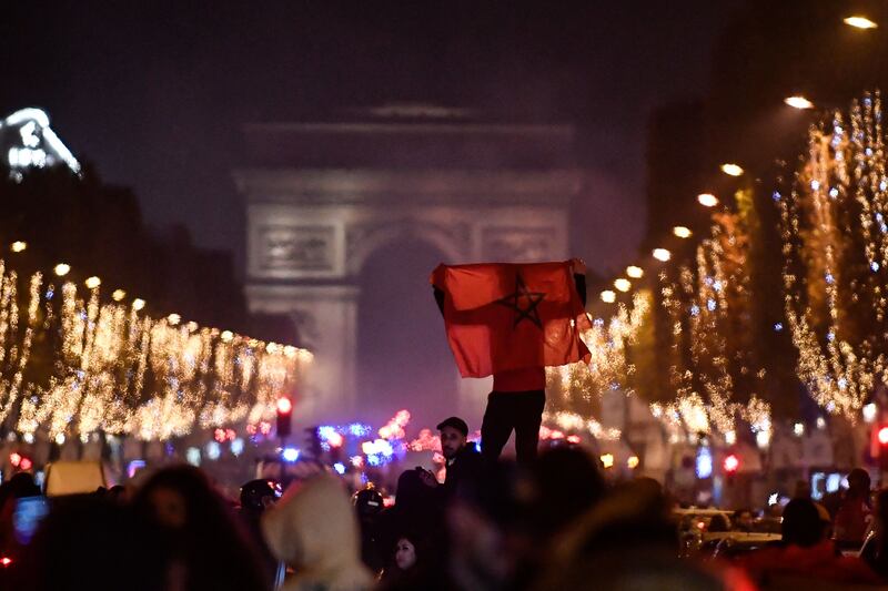 Morocco supporters celebrate in Paris after their team's victory over Spain in the last round.. Photograph: Julien De Rosa/AFP via Getty Images