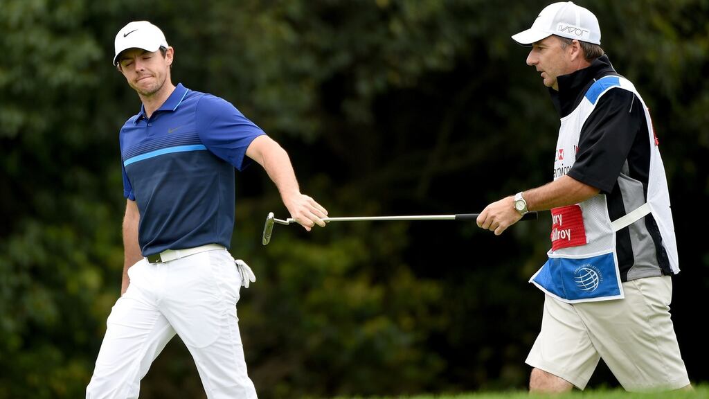 Rory McIlroy of Northern Ireland hands his putter to his caddie JP Fitzgerald during the second round of the WGC - HSBC Champions at the Sheshan International Golf Club. Photograph: Ross Kinnaird/Getty Images