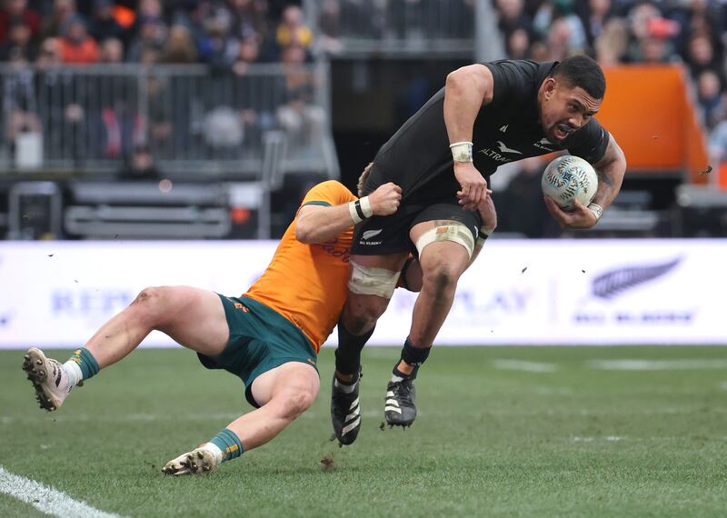 Ardie Savea of New Zealand tries to break the tackle of Tate McDermott of Australia. Photograph: Peter Meecham/Getty