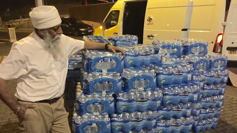 Representatives of the Sikh humanitarian relief organisation Khalsa Aid delivering nearly 6,000 bottles of water along with snacks to stranded motorists heading to Dover. Photograph: Khalsa Aid/PA Wire