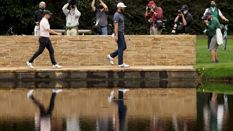 McIlroy and Dustin Johnson walk across the Hogan Bridge during their practice round. Photo: Rob Carr/Getty Images