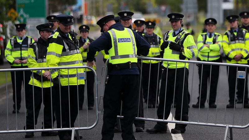 Gardaí watch on as protestors demonstrate at the peace camp on the road to Shannon Airport. Photograph: Brian Lawless/PA Wire.
