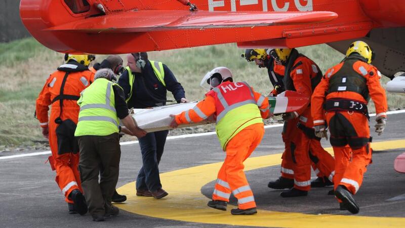 Irish Coast Guard helicopter crash: colleagues of the Rescue 116 crew with wreckage from the Sikorsky S-92. Photograph: Colin Keegan/Collins