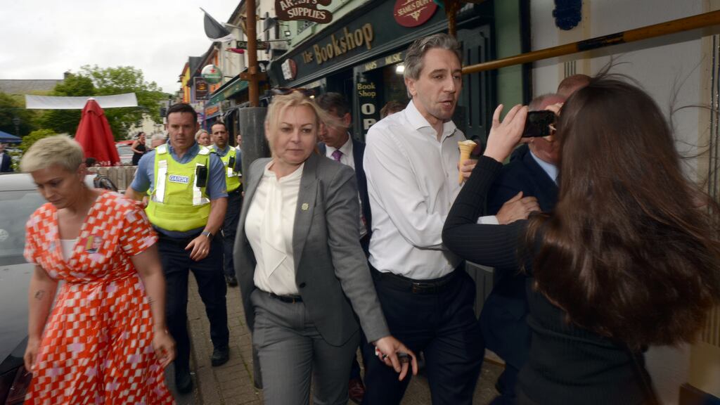 Taoiseach Simon Harris is confronted by members of the Burke family in Westport, Co Mayo. Photograph: Paul Mealey