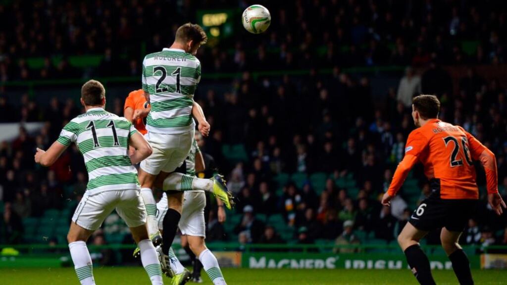 Celtic’s Charlie Mulgrew scores against Dundee United with a late header. Photograph: Russell Cheyne/Reuters