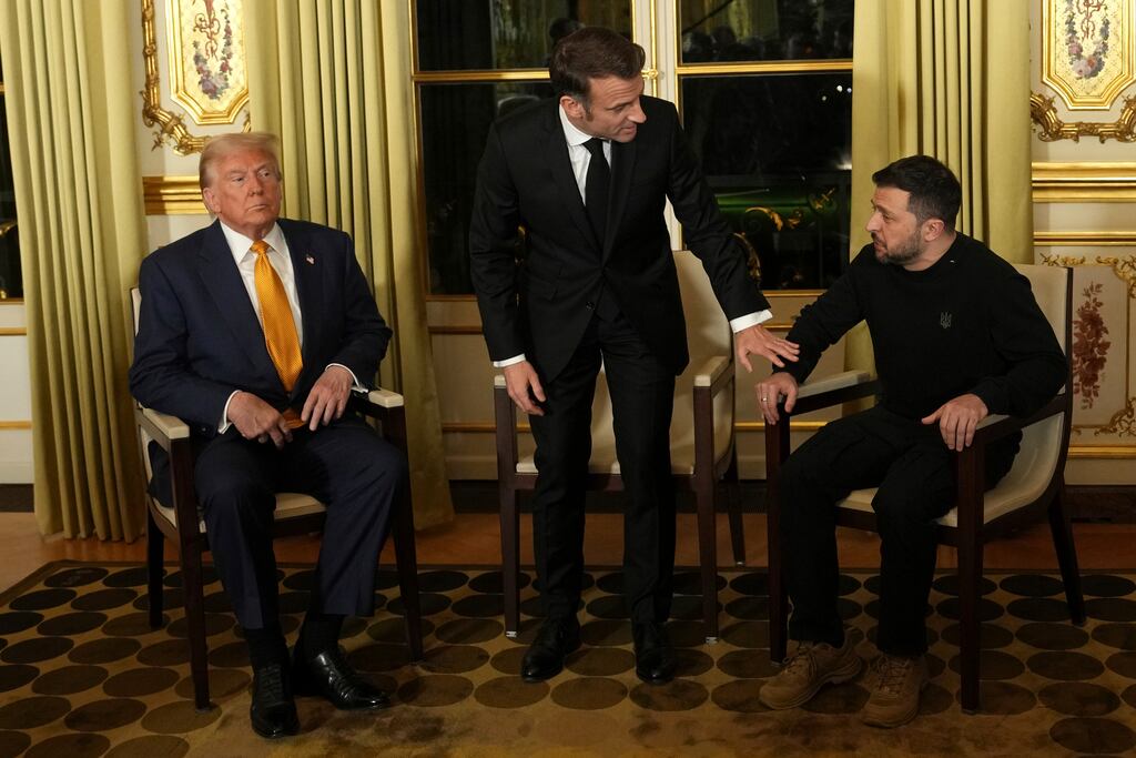 French president Emmanuel Macron, centre, sits with US president-elect Donald Trump, left, and Ukraine’s President Volodymyr Zelenskiy at the Élysée Palace in Paris. Photograph: Aurelien Morissard/AP