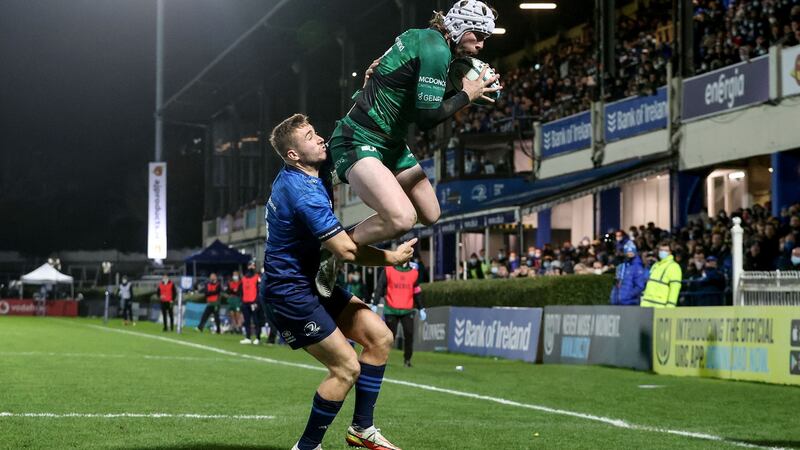 Connacht’s Mack Hansen scores their first try despite the attempts of Leinster’s Jordan Larmour to stop him during the United Rugby Championship game at the RDS. Photograph: Dan Sheridan/Inpho