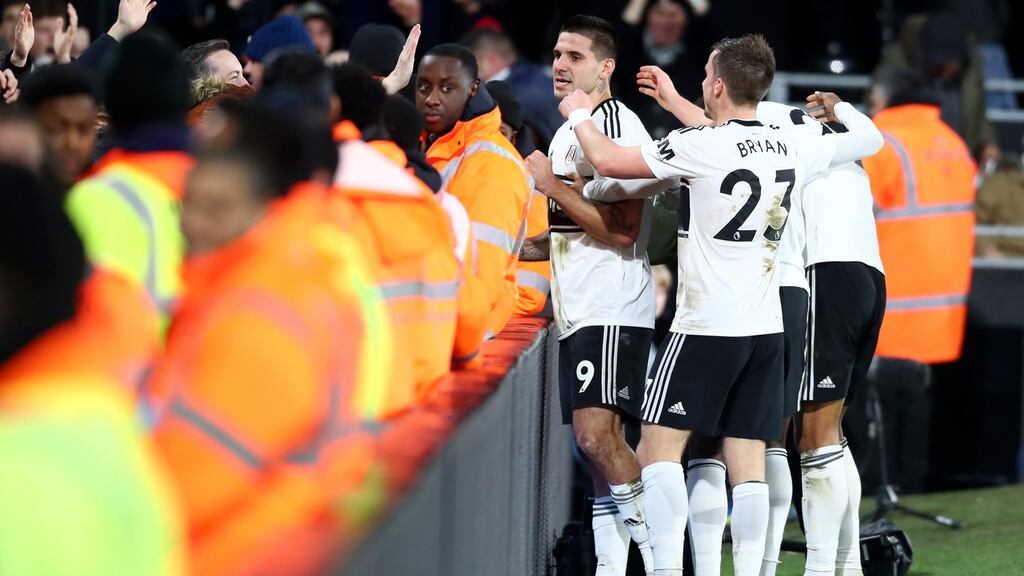 Aleksandar Mitrovic of Fulham celebrates with teammates after he scored his side’s first goal during the Premier League win over Huddersfield Town. Photo: Clive Rose/Getty Images