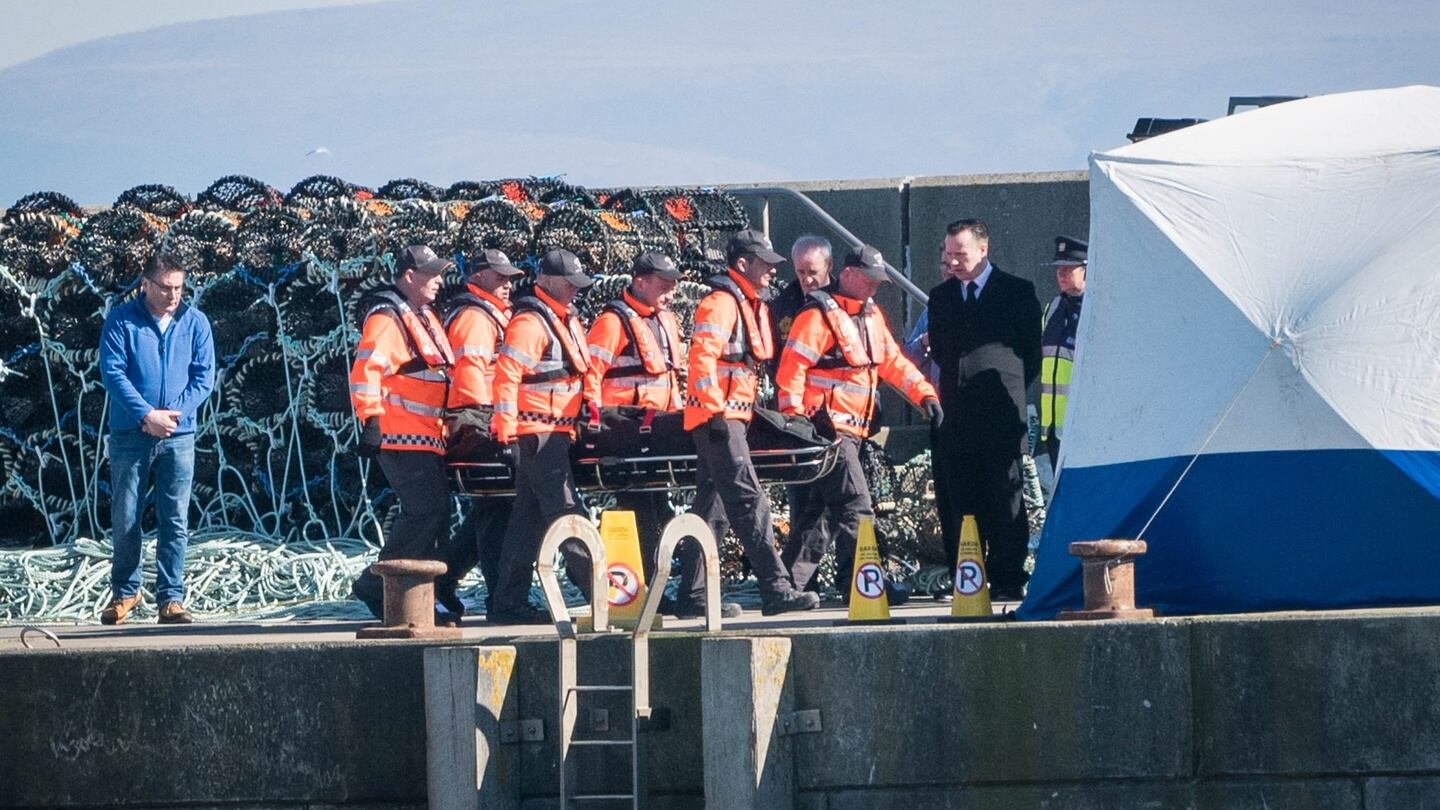 The remains of Capt Mark Duffy one of the missing Rescue 116 helicopter crew is brought into Blacksod Pier, Belmullet, Co. Mayo. Photograph: Keith Heneghan/Phocus