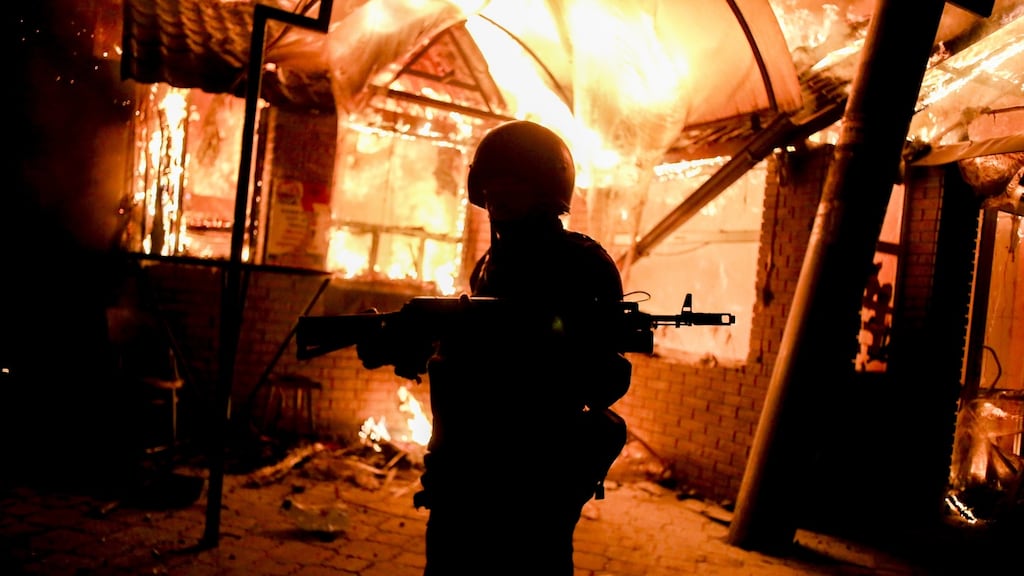 A separatist soldier at a building shelled by the Ukrainian army: The Red Cross says more than 1,000 people are missing as a result of two years of fighting, which has killed almost 10,000 people and displaced some two million. Photograph: NurPhoto/Corbis/Getty Images