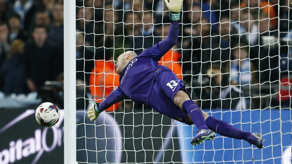 Manchester City’s Willy Caballero saves a penalty  by Liverpool’s Adam Lallana  during the  shootout. Photograph:  Eddie Keogh/Reuters/Livepic