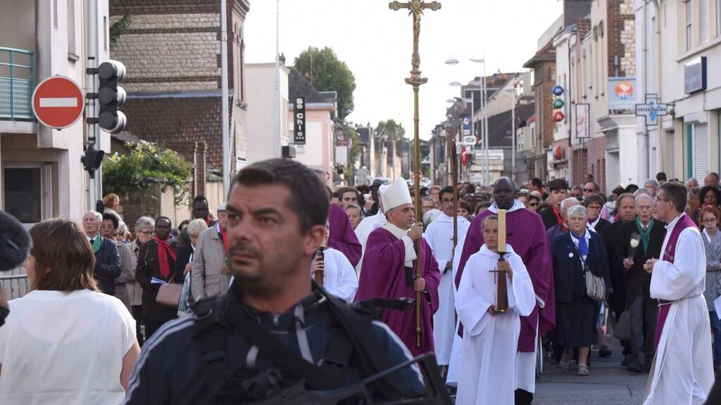 Archbishop of Rouen and Primate of Normandy Mgr Dominique Lebrun carries a crucifix as he leads a procession, under security measures, to the memory of slain French priest, Fr Jacques Hamel. Photograph:  Steve Bonet/Reuters