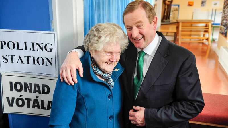 Taoiseach Enda Kenny talls to local resident Bridie McLaughlin after he cast his vote in Castlebar. Photograph: Aidan Crawley/Bloomberg