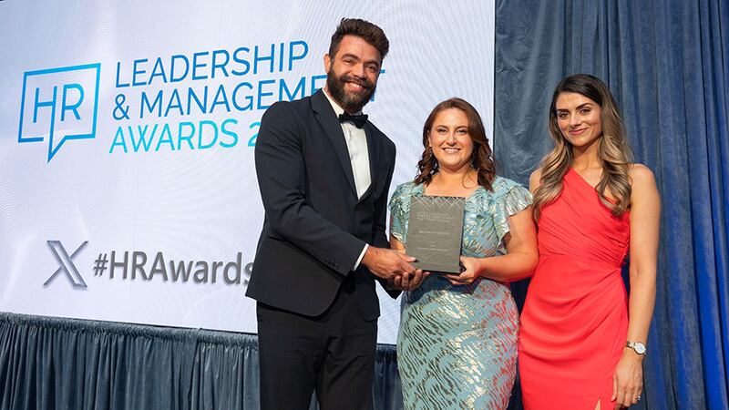 Aricio Silvestre, awards judge, presents best use of CSR in HR award to Sharon Vize, Cpl