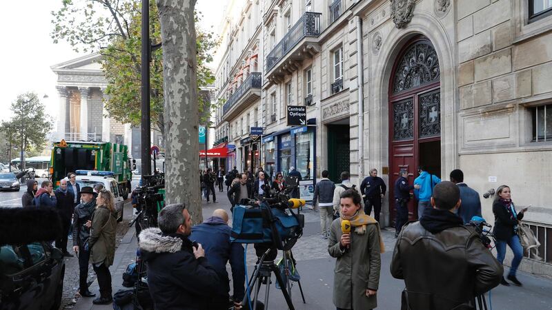Journalists work as police officers stand guard at the entrance to a hotel residence at the Rue Tronchet, near Madeleine, central Paris, where Kim Kardashian was robbed at gunpoint. Photograph: AFP/Getty Images