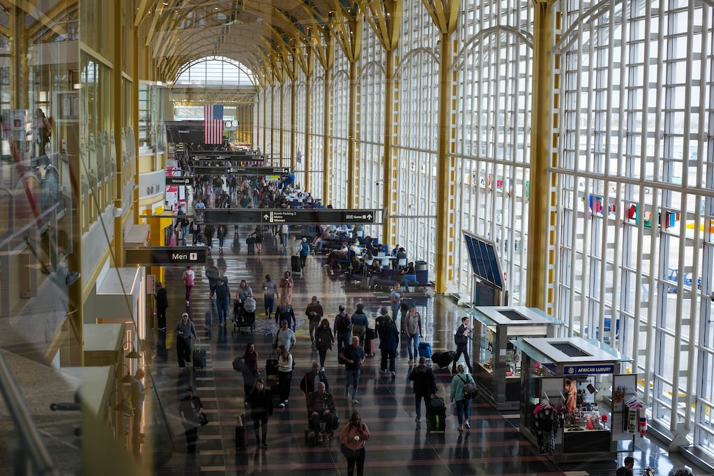 Passengers at Reagan National Airport in Washington: The Federal Aviation Administration has required airlines to cut flights to reduce the strain on air traffic controllers, who have gone weeks without a paycheck. (Photo: Andrew Leyden/The New York Times)