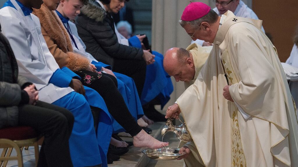 Archbishop Diarmuid Martin performs the Washing of the Feet ceremony  on Thursday, including members of the Palestrina Boys Choir. Photograph: Dave Meehan