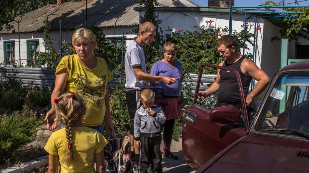 After hiding in a basement during artillery shelling that preceded the ceasefire, a family prepares to leave their home in Lebedynske, Ukraine, a village east of Mariupol today. Photograph: Mauricio Lima/The New York Times