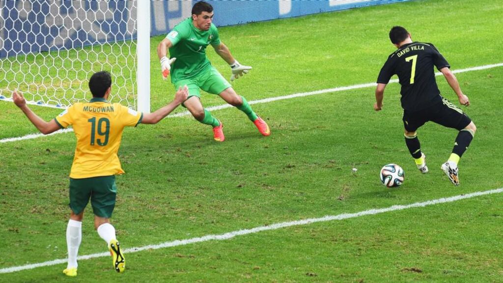 David Villa flicks the ball past Australian goalkeeper Mathew Ryan. Photograph: David Ramos/Getty Images