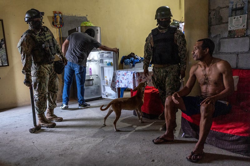 Ecuadorian soldiers speak with a resident while searching his home for illegal weapons and drugs during an anti-gang operation on Monday in Guayaquil. Photograph: John Moore/Getty Images