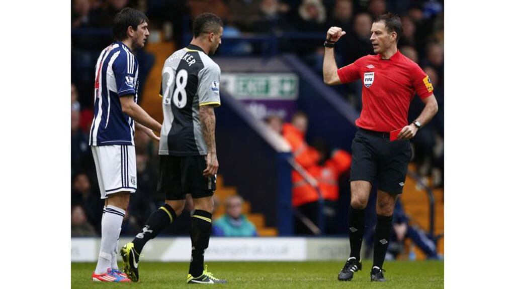 West Bromwich Albion's Goran Popov (left) is sent off by referee Mark Clattenburg after spitting at Kyle Walker (centre). Photograph: Darren Staples/Reuters