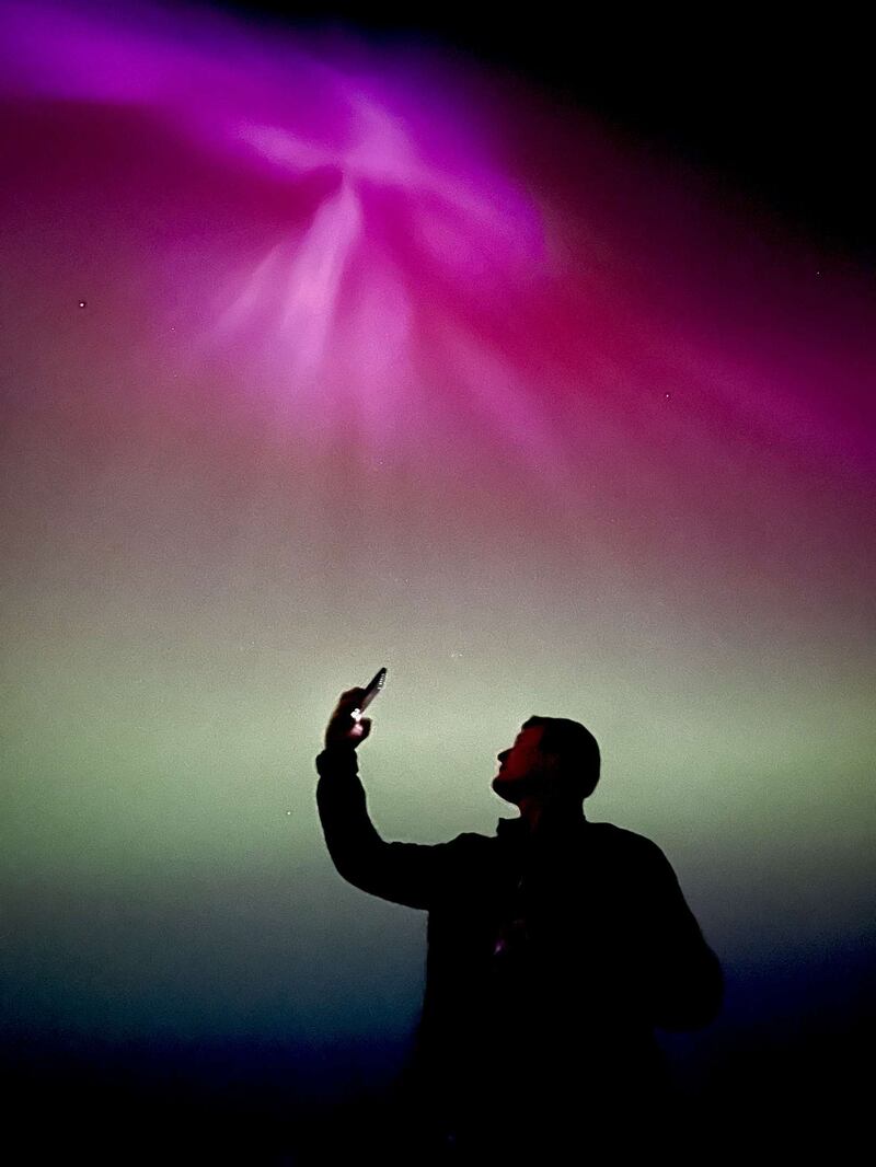 A man points his smart phone to the aurora on Friday night in Co Roscommon. Photograph: Zoe O'Callaghan.