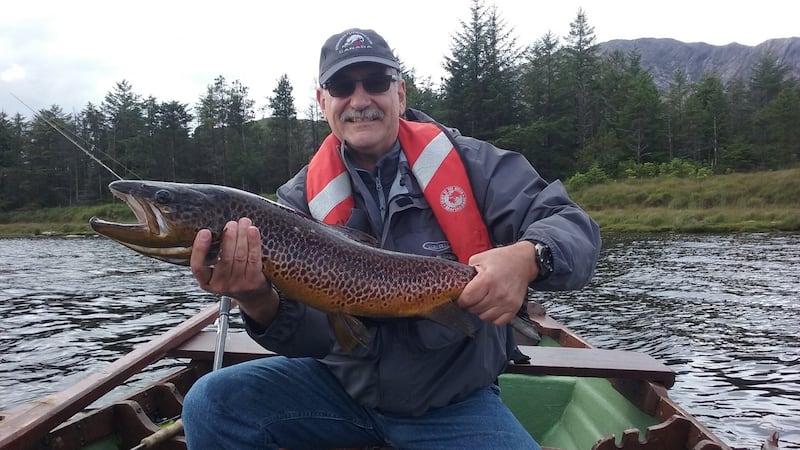 Baet Suez (Switzerland), with a magnificent 8lb brown trout from Lough Inagh on a Blue Butcher fly.