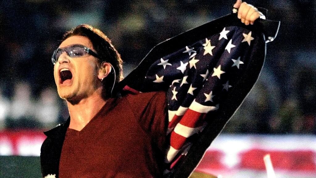 ‘There is a massive patriotic messaging around sports events’: U2 lead singer Bono shows the stars and stripes of the US flag during the 2002 Super Bowl halftime show. Win Mcnamee/Reuters
