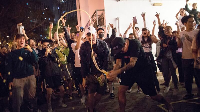 Pro-democracy supporters celebrate the defeat of a pro-Beijing district councillor in Hong Kong, China, on Monday. Photograph: EPA