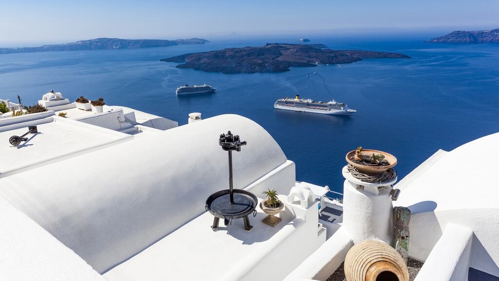 Cruise ships pass Santorini Island in Greece