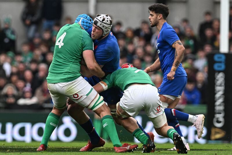 France lock Thibaud Flament is tackled by Tadhg Beirne and Josh van der Flier during the game at the Aviva Stadium. Photograph: Paul Ellis/AFP via Getty Images